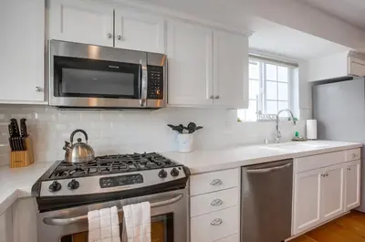 a kitchen with a stove and a microwave at Pacific Pearl in San Diego