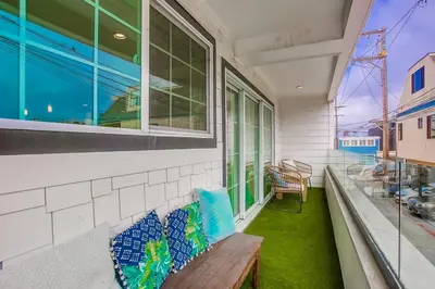 a porch with a bench and a window at Pacific Pearl in San Diego