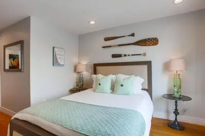 a bedroom with a bed with a oar on the wall at Pacific Pearl in San Diego