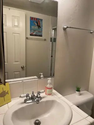 a bathroom with a sink and a large mirror at South Mission Oceanview Beach Duplex in San Diego