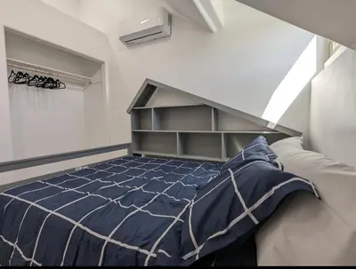 a bedroom with a bed with a blue comforter at Best Location pet friendly Home just renovated in Chula Vista