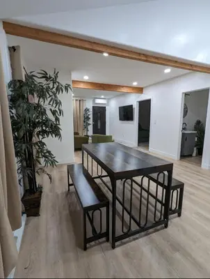 a dining room with a table and a plant at Best Location pet friendly Home just renovated in Chula Vista