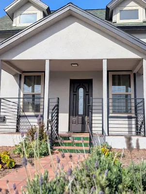 a house with a black door and a porch at Best Location pet friendly Home just renovated in Chula Vista