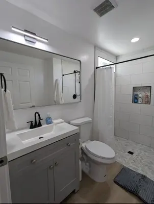 a bathroom with a sink and a toilet and a mirror at Best Location pet friendly Home just renovated in Chula Vista