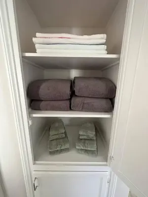 a closet with towels and folded towels at 500 ft to Ocean Relaxing stay Parking WiFi 838 in San Diego