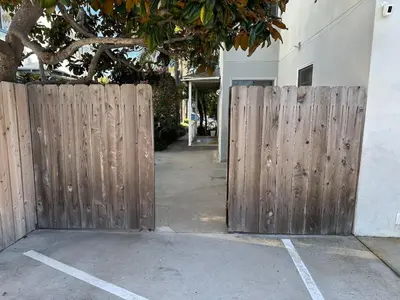 a wooden fence in front of a building at 500 ft to Ocean Relaxing stay Parking WiFi 838 in San Diego