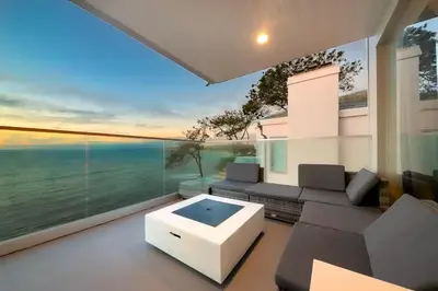 a living room with a couch and a large window at Cliffside Haven Where Ocean Meets Sky in San Diego