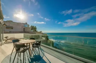 a balcony with a table and chairs and the ocean at Cliffside Haven Where Ocean Meets Sky in San Diego