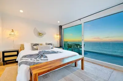 a bedroom with a bed and a view of the ocean at Cliffside Haven Where Ocean Meets Sky in San Diego