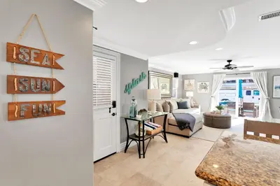 a living room with a couch and a table at Beach Escape with Patio! 2 Min Walk to Sand & Surf in Newport Beach