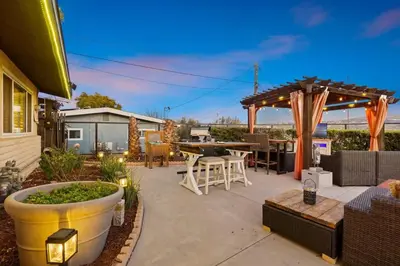 a patio with a table and chairs and an umbrella at Mountain Majesty with AC BBQ Parking in Lemon Grove