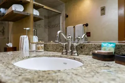 a bathroom counter with a sink and a mirror at Mountain Majesty with AC BBQ Parking in Lemon Grove