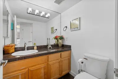 a bathroom with a sink and a toilet at Townhouse 1 Block From Bay With Yard & Parking in San Diego