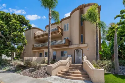 a house with palm trees in front of it at Townhouse 1 Block From Bay With Yard & Parking in San Diego