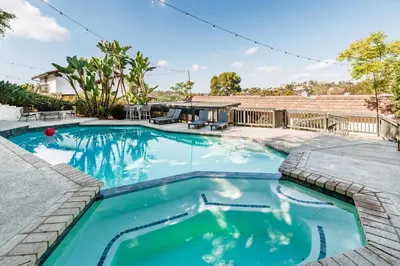 a swimming pool with blue water in a house at 5BR Oasis with Pool, Arcade, Sauna in La Mesa
