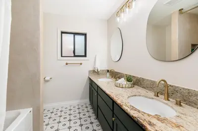 a bathroom with two sinks and a mirror at 5BR Oasis with Pool, Arcade, Sauna in La Mesa