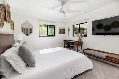 a white bedroom with a bed and a desk at 5BR Oasis with Pool, Arcade, Sauna in La Mesa