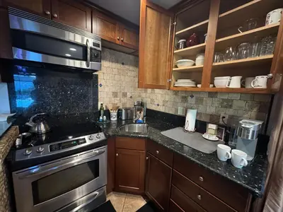 a kitchen with a stove and a sink at Guesthouse in Coastal Del Mar, California in San Diego