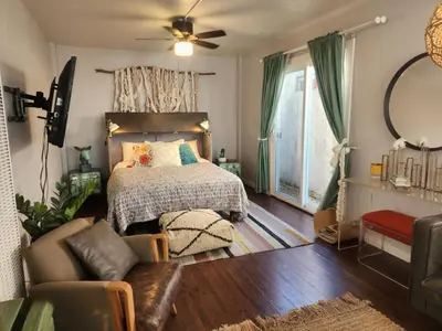 a bedroom with a bed and a living room at Urban Beach Getaway 2 in San Diego