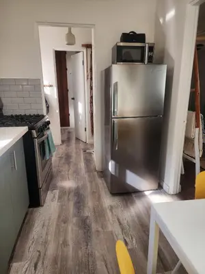 a kitchen with a stainless steel refrigerator with a microwave at Urban Beach Getaway 2 in San Diego