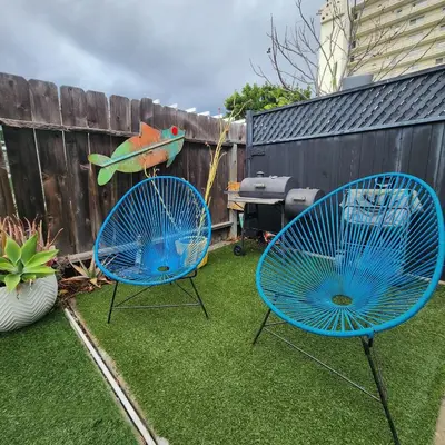 two blue chairs sitting on the grass in a backyard at Urban Beach Getaway 2 in San Diego