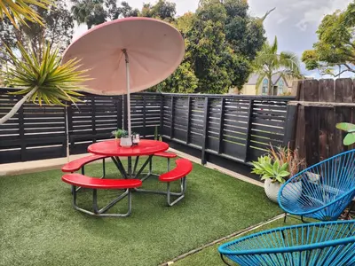 a patio with a table and two chairs and an umbrella at Urban Beach Getaway 2 in San Diego