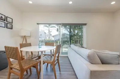 a living room with a couch and a table and chairs at Outsite San Diego - Encinitas Avocado in Encinitas