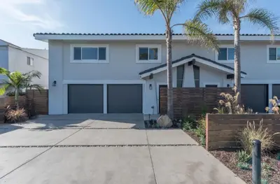 a white house with palm trees and a driveway at Outsite San Diego - Encinitas Avocado in Encinitas
