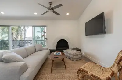a living room with a couch and a flat screen tv at Outsite San Diego - Encinitas Avocado in Encinitas
