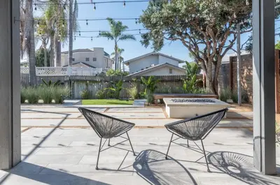 two chairs sitting on a patio in a yard at Outsite San Diego - Encinitas Avocado in Encinitas