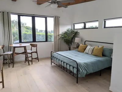 a bedroom with a bed and a table and chairs at Newly Built, secluded, and tranquil Nest in Olivenhain in Encinitas