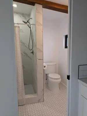 a bathroom with a toilet and a glass shower at Newly Built, secluded, and tranquil Nest in Olivenhain in Encinitas