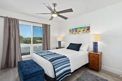a bedroom with a bed and a ceiling fan at Live in the Sunshine-DMBC148N in Solana Beach