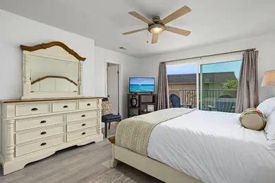 a bedroom with a bed and a dresser and a window at Live in the Sunshine-DMBC148N in Solana Beach