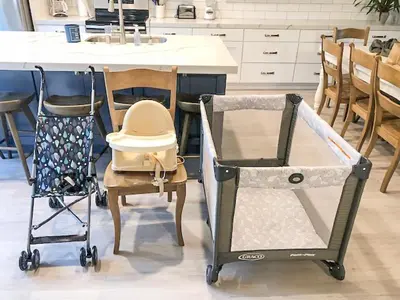 a kitchen with a baby crib and a table and chairs at Live in the Sunshine-DMBC148N in Solana Beach