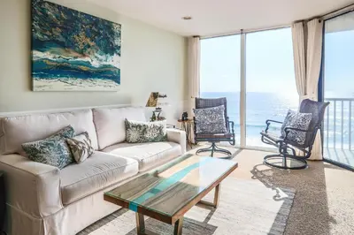 a living room with a couch and a glass table at Sea La Vie - DMST17 in Solana Beach