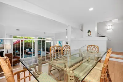 a dining room with a glass table and chairs at Seaside Shenanigans - DMBC751P in Solana Beach
