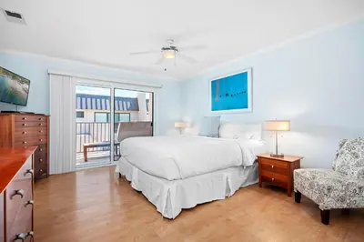 a bedroom with a bed and a chair and a window at Seaside Shenanigans - DMBC751P in Solana Beach