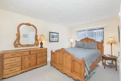 a bedroom with a bed and a mirror on a dresser at Blissful SEA'renity - DMBC850S in Solana Beach