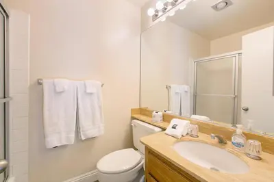 a bathroom with a sink and a toilet and a mirror at Blissful SEA'renity - DMBC850S in Solana Beach