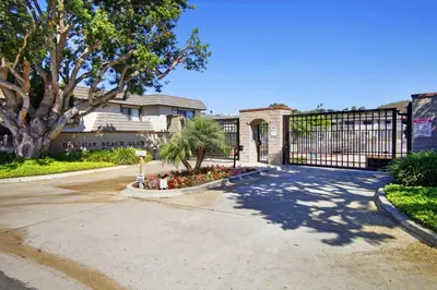 a driveway with a gate in front of a house at Blissful SEA'renity - DMBC850S in Solana Beach