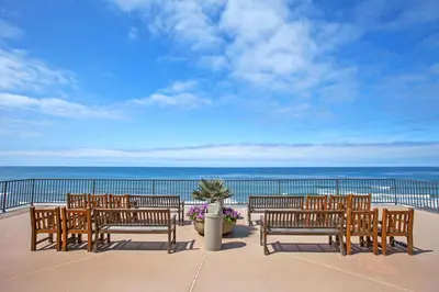 a row of benches sitting on a balcony overlooking the ocean at Blissful SEA'renity - DMBC850S in Solana Beach