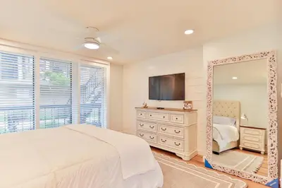 a bedroom with a large mirror and a tv at Breathtaking Bungalow - DMST22 in Solana Beach
