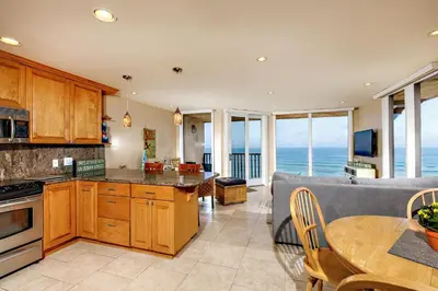 a kitchen and dining room with the ocean view at Enjoy Some Sea-clusion-DMST25 in Solana Beach