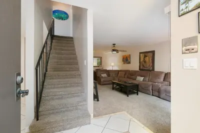 a stairway leading to a living room with a couch at Second Wind - DMBC756S in Solana Beach