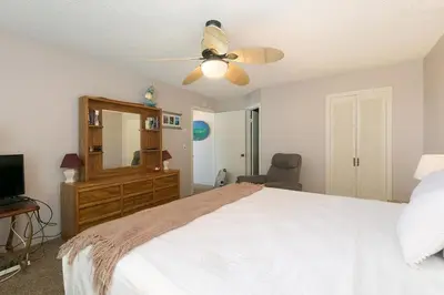 a bedroom with a white bed and a ceiling fan at Second Wind - DMBC756S in Solana Beach