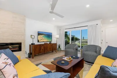 a living room with a couch and chairs and a tv at Happy Days - SBTC101 in Solana Beach