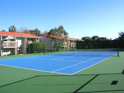 a tennis court in front of a house at Happy Days - SBTC101 in Solana Beach