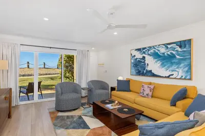a living room with a yellow couch and chairs at Happy Days - SBTC101 in Solana Beach