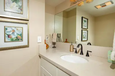 a bathroom with a sink and a mirror at Above the Waves - SUR116 in Solana Beach